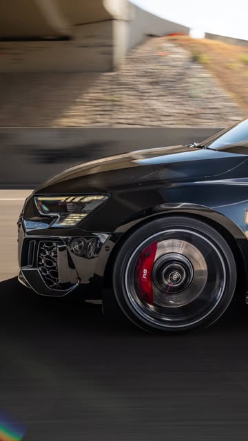Audi RS 3 rolling shot with red brake calipers